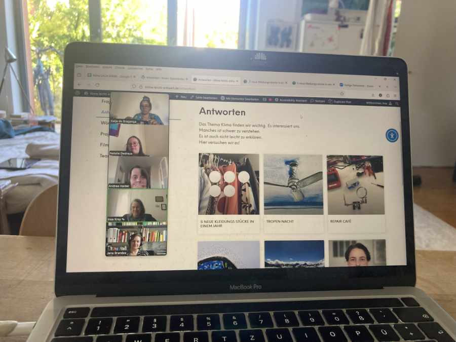 Ein offener Laptop, darauf sind mehrere Frauen zu sehen. Rechts neben ihnen ist die Website des Projektes Klima Leicht Erklärt zu sehen
